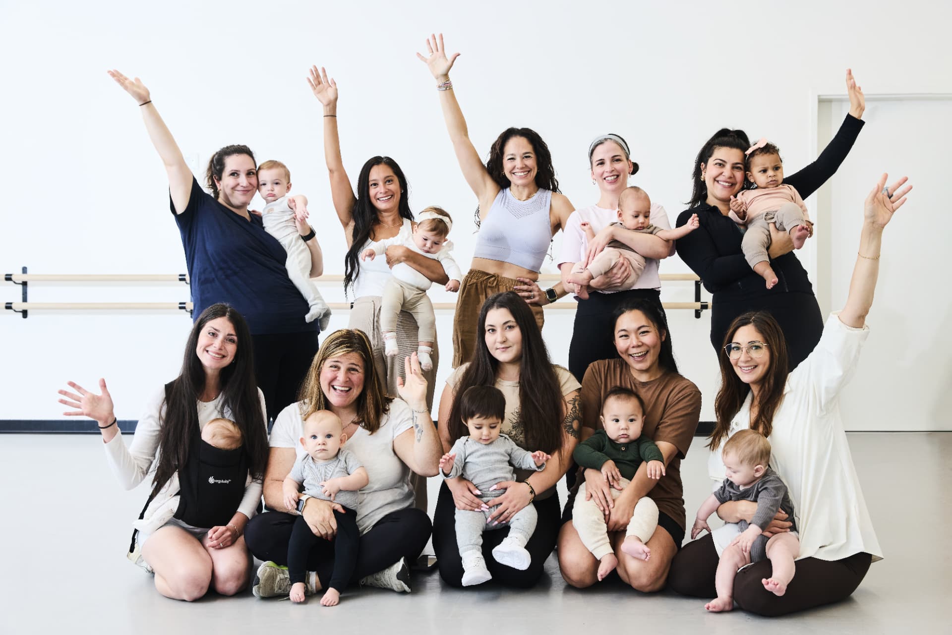 Boogie Babies moms and babies posing together for a cheerful studio group photo